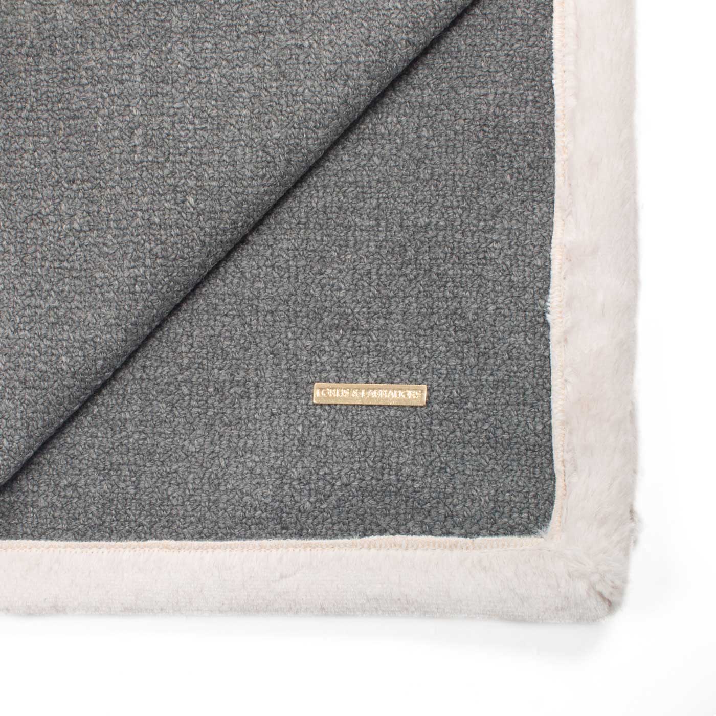 Present your furry friend with our luxuriously thick, plush blanket for your pet. Featuring a reverse side with hardwearing woven fabric handmade in Italy for the perfect high-quality pet blanket! Essentials Herdwick Blanket In Graphite, Available now at Lords & Labradors