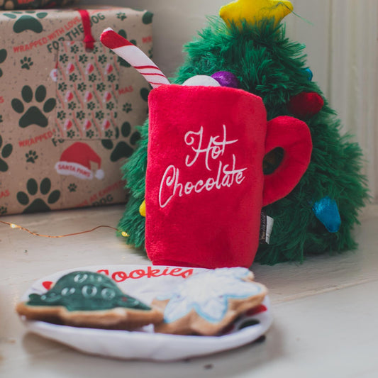 P.L.A.Y hot chocolate plush toy in front of plush Christmas tree