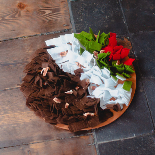 Rosewood Christmas pudding snuffle mat in front of fireplace